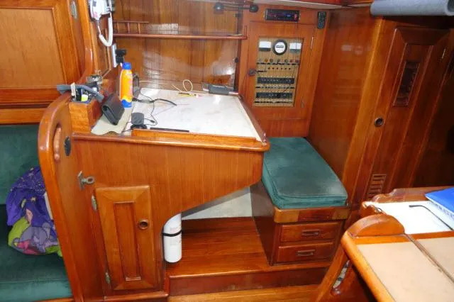 Slide: The Image of 1976 Peterson 44 yacht interior with navigation station and wooden cabinetry. - 16