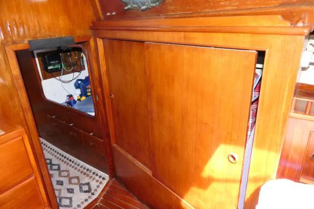 Slide: The Image of Interior of 1976 Peterson 44 sailboat with wooden paneling and nautical decor. - 28
