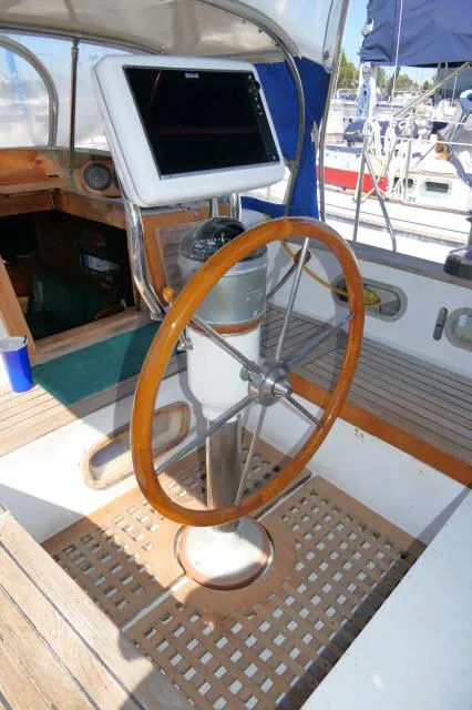 Slide: The Image of Steering wheel of a 1976 Peterson 44 sailboat with navigation equipment. - 31