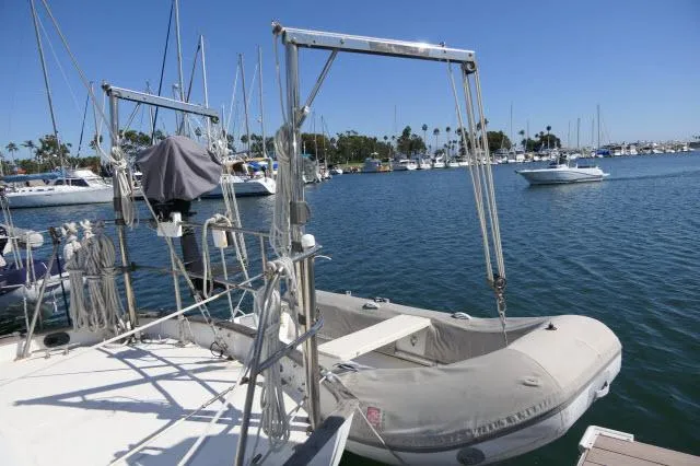Slide: The Image of Sailboat with dinghy in marina, Peterson 44, 1976 model, clear blue sky. - 34