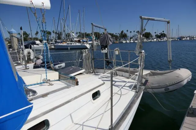 Slide: The Image of 1976 Peterson 44 sailboat docked in marina with inflatable dinghy. - 35