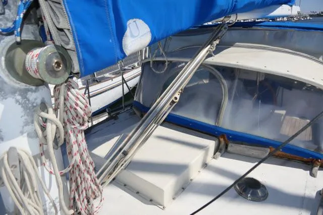 Slide: The Image of 1976 Peterson 44 sailboat deck with blue sail cover and rigging. - 36
