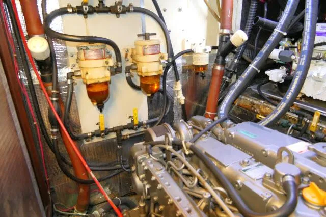 Slide: The Image of Engine room of a 1976 Peterson 44 boat with fuel filters and mechanical components. - 43