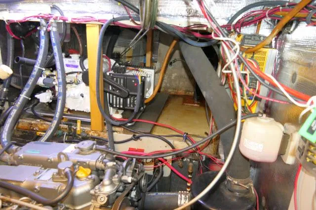 Slide: The Image of Engine room of a 1976 Peterson 44 boat with wiring and machinery. - 44