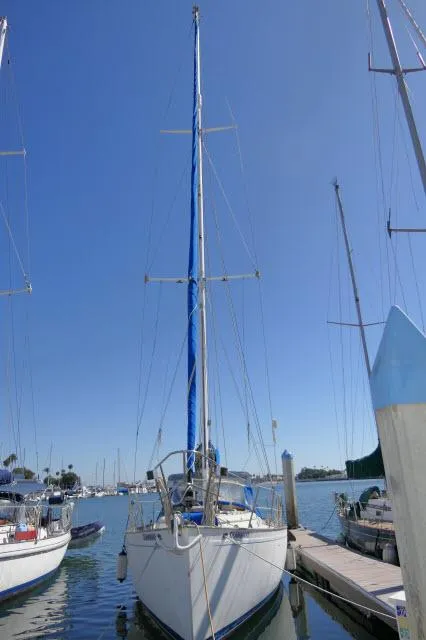 Slide: The Image of 1976 Peterson 44 sailboat docked at marina under clear blue sky. - 45