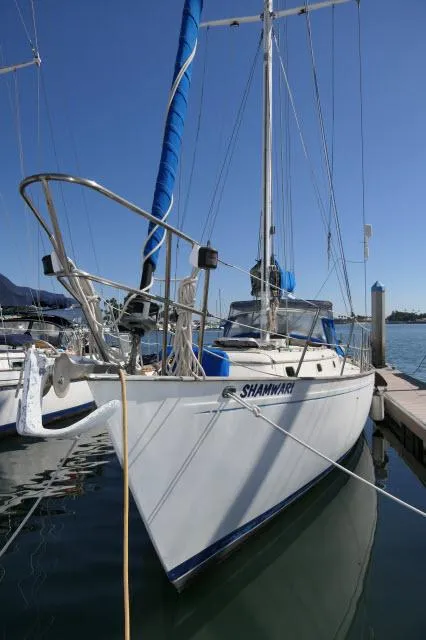 Slide: The Image of 1976 Peterson 44 sailboat docked in marina under clear blue sky. - 46