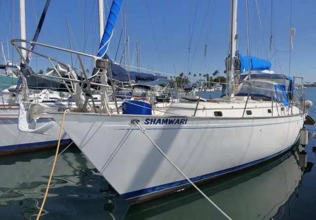 Slide: The Image of 1976 Peterson 44 sailboat "Shamwari" docked in a marina. - 48