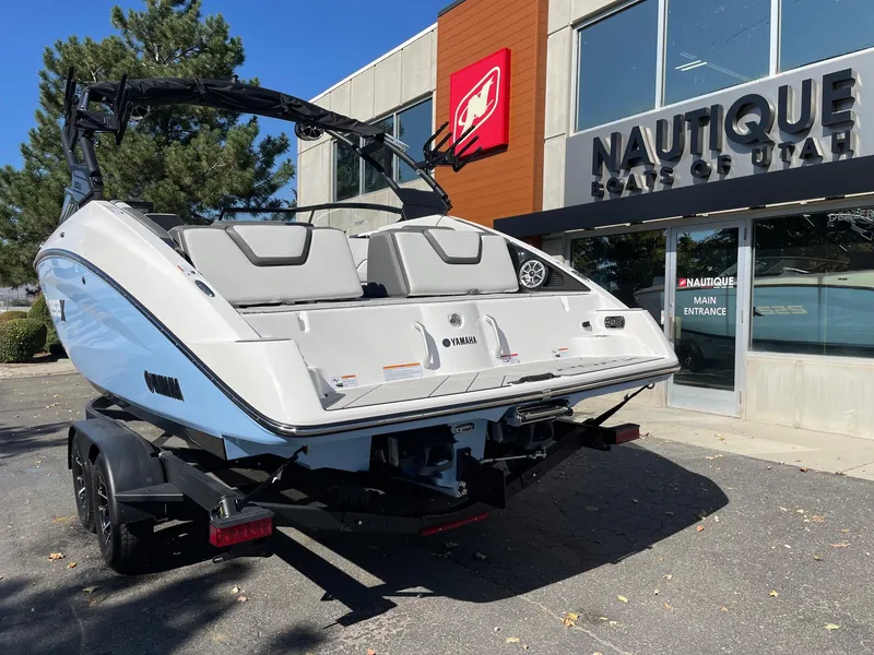 Slide: The Image of 2024 Yamaha Boats 252XE displayed outside Nautique dealership. - 2