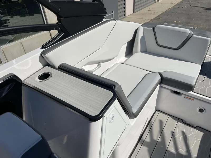 Slide: The Image of 2024 Yamaha Boats 252XE interior seating with sleek, modern design and cup holder. - 6