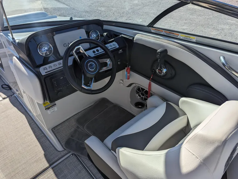 Slide: The Image of 2023 Crownline 260 SS boat cockpit with modern steering and dashboard controls. - 23