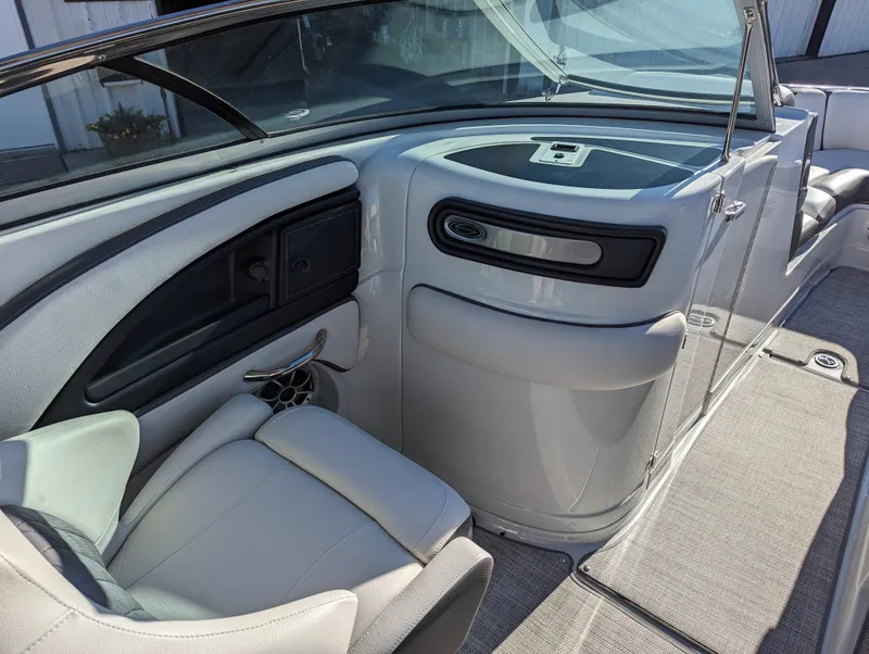 Slide: The Image of 2023 Crownline 260 SS boat interior with sleek seating and modern dashboard design. - 24