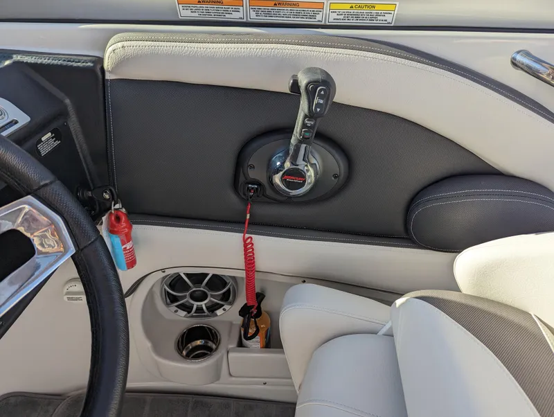 Slide: The Image of Interior of 2023 Crownline 260 SS boat, featuring control panel and seating. - 27