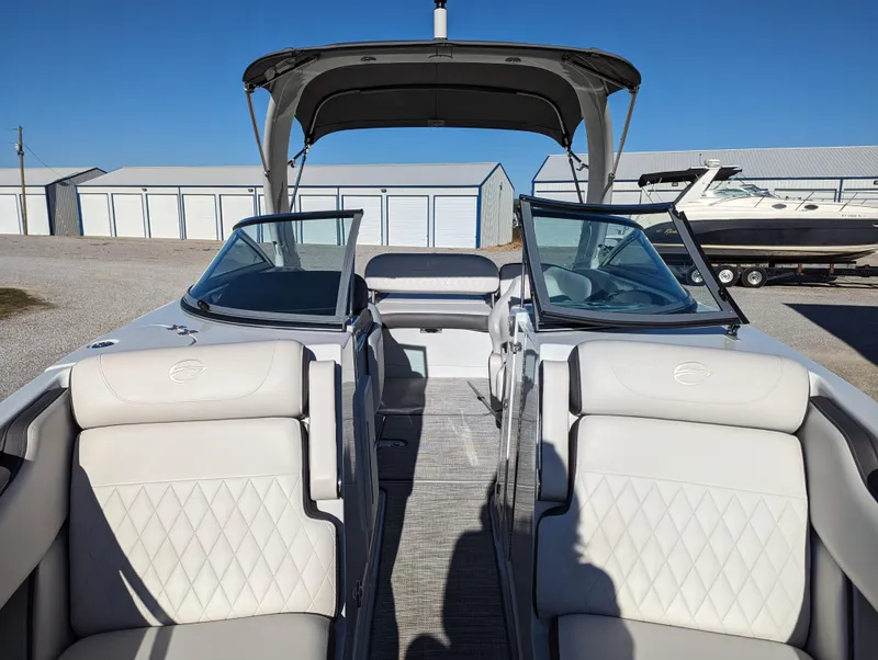 Slide: The Image of 2023 Crownline 260 SS boat interior with white seating and open cockpit. - 30