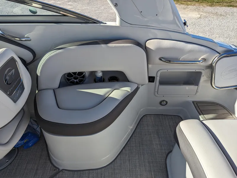Slide: The Image of 2023 Crownline 260 SS boat interior with gray seating and storage compartments. - 34