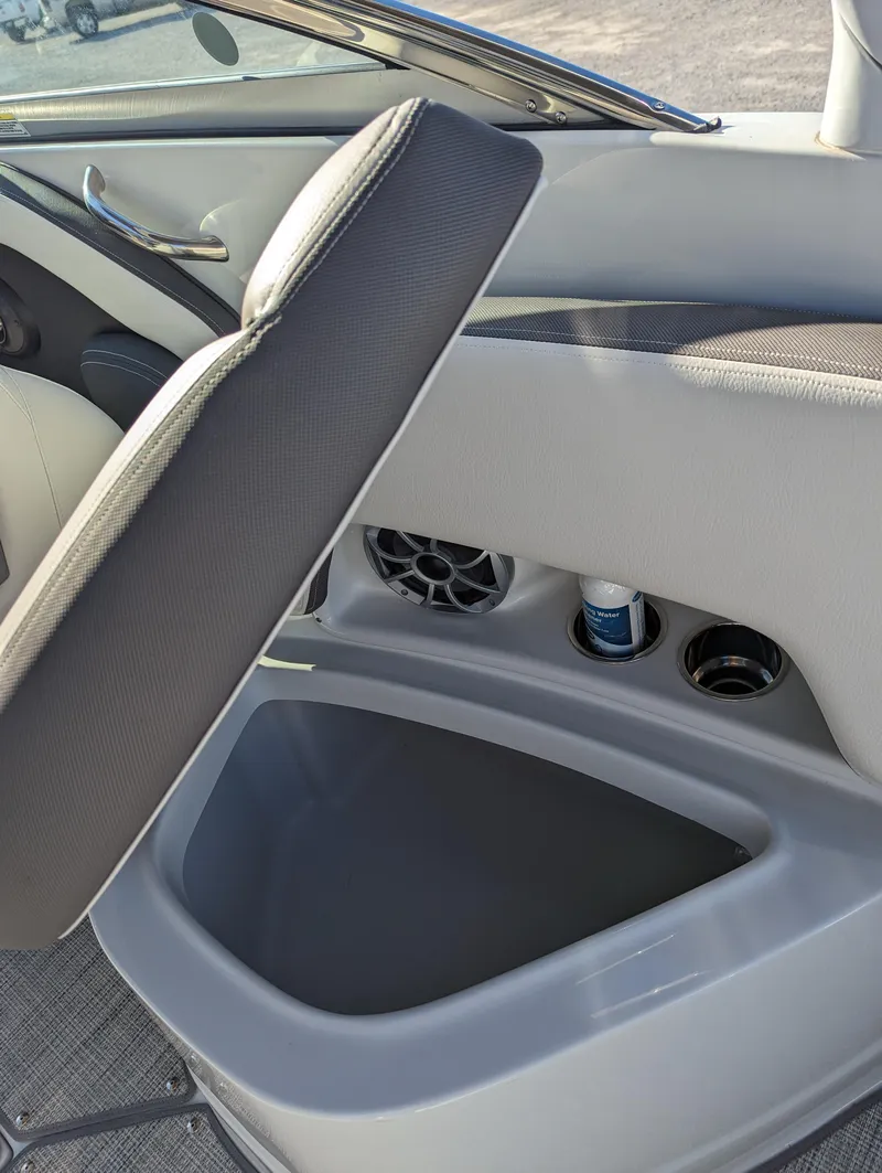 Slide: The Image of 2023 Crownline 260 SS boat interior storage compartment with cup holders and speaker. - 38