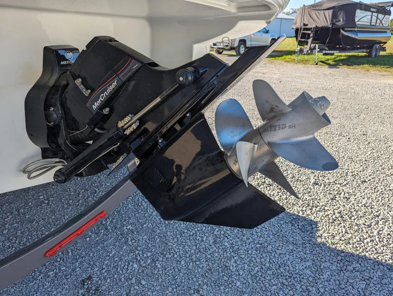 Slide: The Image of 2023 Crownline 260 SS boat with MerCruiser outdrive and stainless steel propeller on gravel surface. - 42