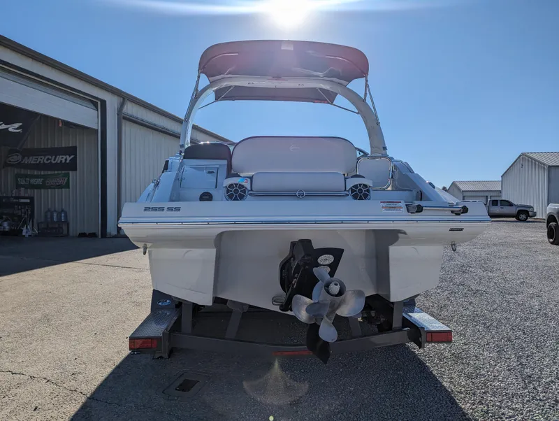 Slide: The Image of 2023 Crownline 260 SS boat on trailer, rear view, in sunny outdoor setting. - 9