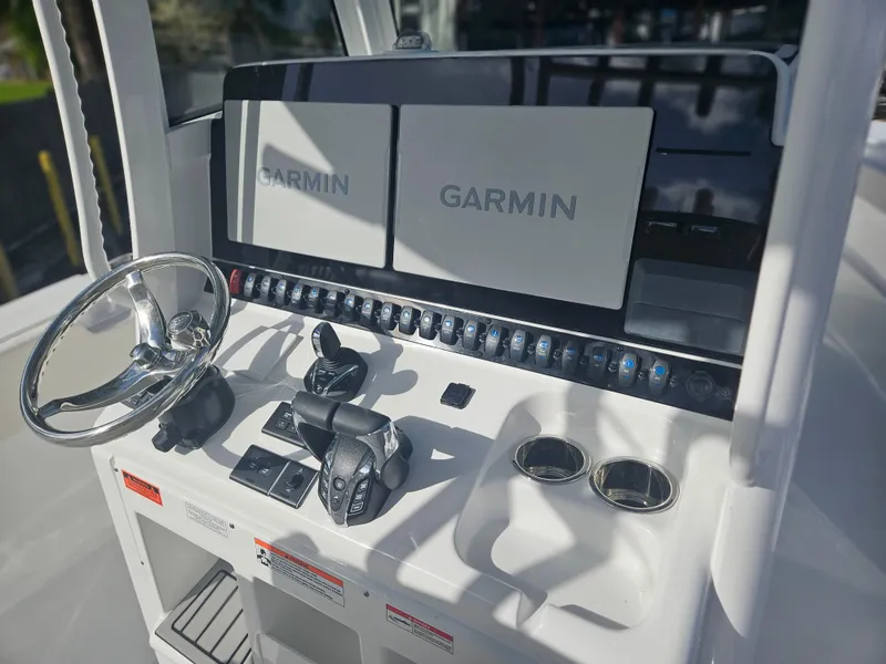 Slide: The Image of 2025 Sea Hunt Gamefish 28 CB helm with Garmin displays and controls. - 12