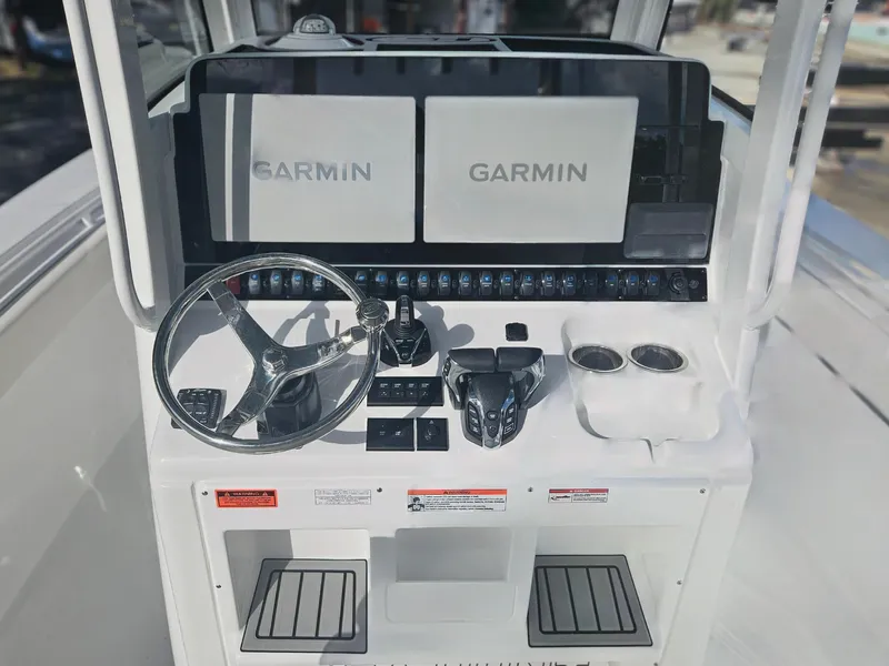Slide: The Image of 2025 Sea Hunt Gamefish 28 CB helm with dual Garmin displays and steering wheel. - 14