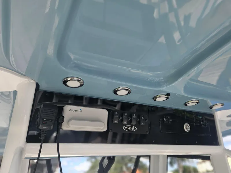 Slide: The Image of 2025 Sea Hunt Gamefish 28 CB console with Garmin electronics and overhead lighting. - 15