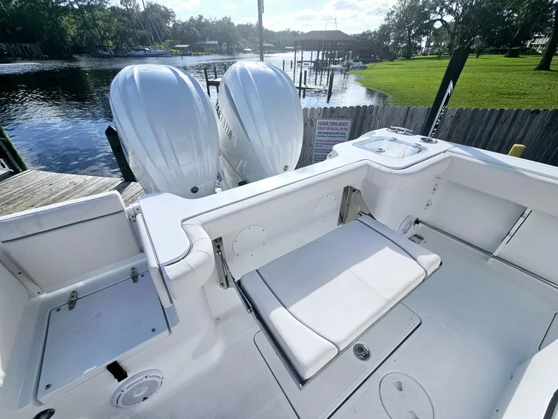 Slide: The Image of 2025 Sea Hunt Gamefish 28 CB boat with dual engines, spacious seating, and scenic waterfront view. - 18