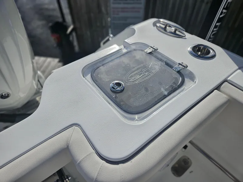 Slide: The Image of 2025 Sea Hunt Gamefish 28 CB boat console detail with storage compartment. - 21