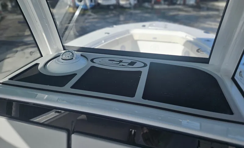 Slide: The Image of 2025 Sea Hunt Gamefish 28 CB dashboard with compass and storage compartments. - 22