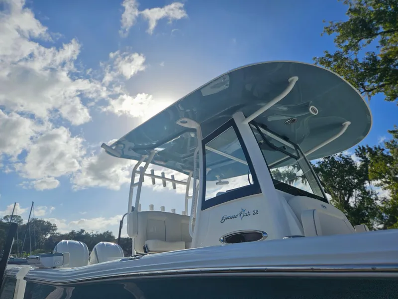 Slide: The Image of 2025 Sea Hunt Gamefish 28 CB boat under a clear blue sky. - 32