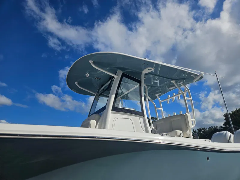 Slide: The Image of 2025 Sea Hunt Gamefish 28 CB boat under a clear blue sky. - 33
