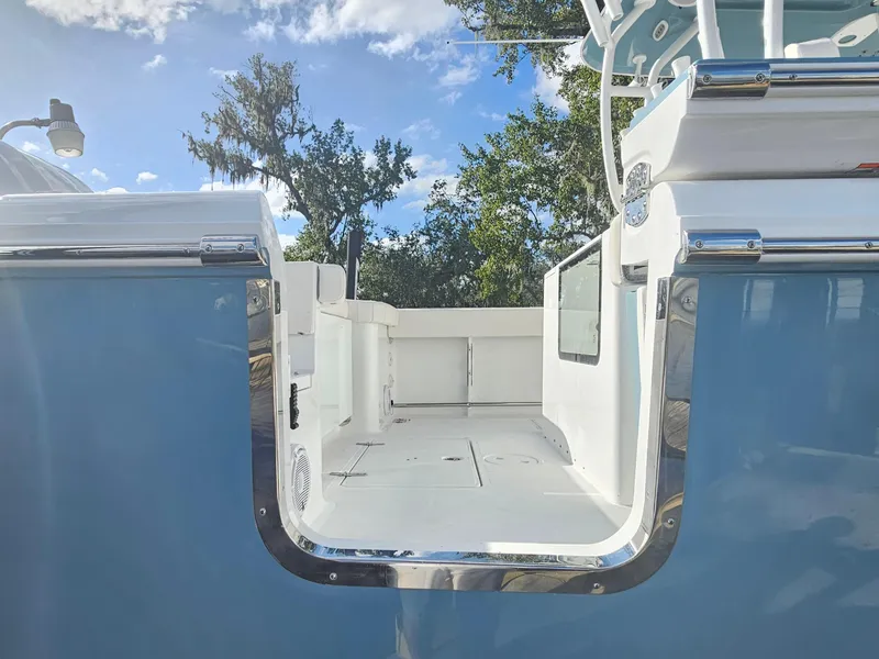 Slide: The Image of 2025 Sea Hunt Gamefish 28 CB boat interior with open deck and blue exterior. - 5