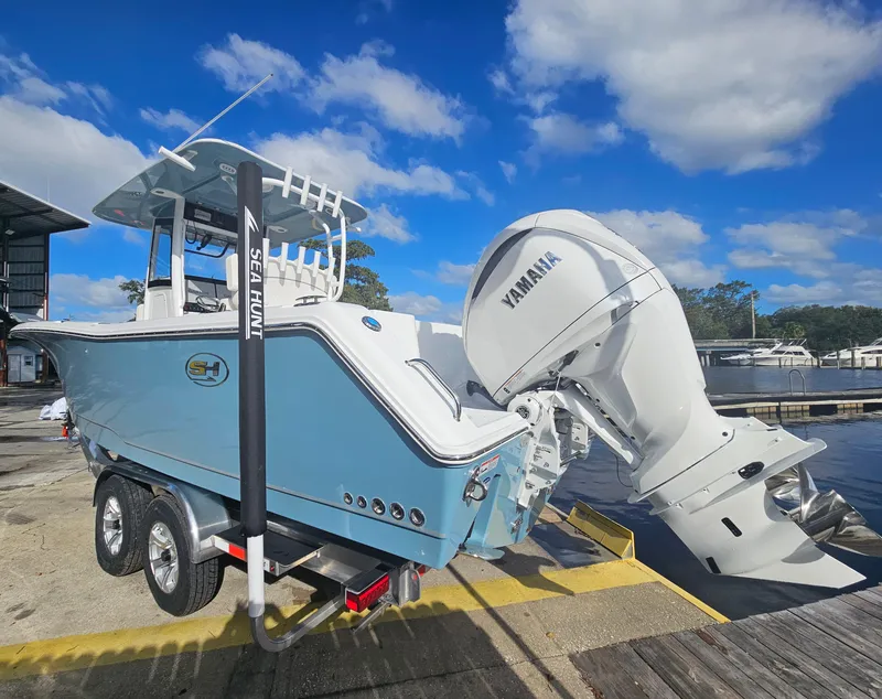 Slide: The Image of 2025 Sea Hunt Gamefish 28 CB boat with Yamaha engine at dock. - 6