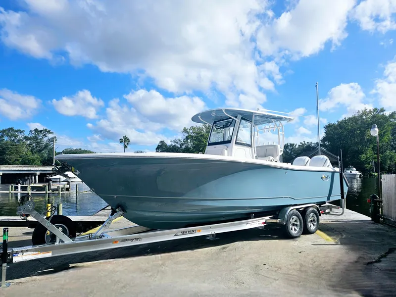 Slide: The Image of 2025 Sea Hunt Gamefish 28 CB boat on trailer under blue sky. - 8
