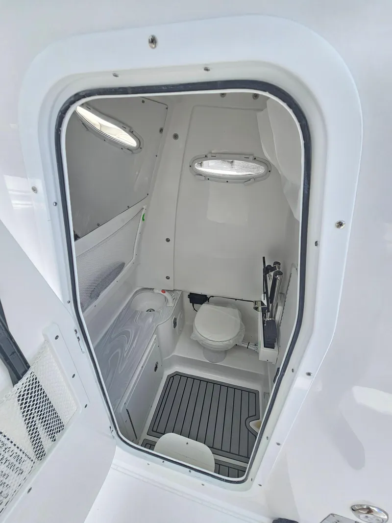 Slide: The Image of 2025 Sea Hunt Gamefish 28 CB boat interior with compact bathroom and modern amenities. - 28