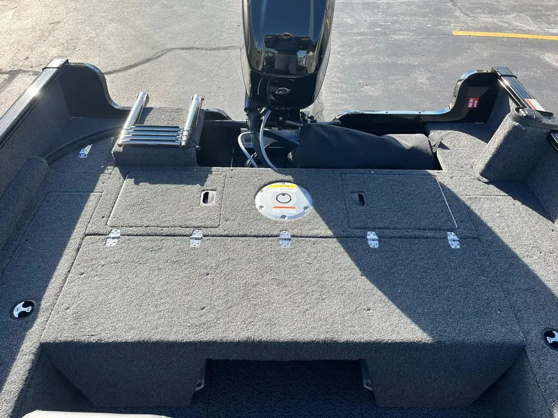 Slide: The Image of 2025 Lund 1650 Rebel XL SS boat interior with motor and storage compartments. - 10