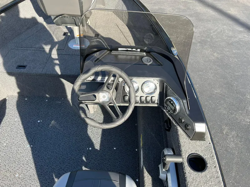 Slide: The Image of 2025 Lund 1650 Rebel XL SS boat dashboard with steering wheel and controls. - 13