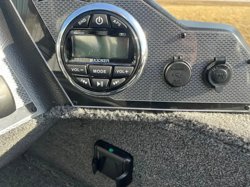 Slide: The Image of 2025 Lund 1650 Rebel XL SS dashboard with Kicker audio system and 12V power outlets. - 15