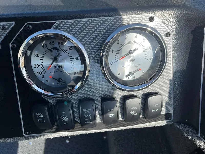 Slide: The Image of Dashboard of 2025 Lund 1650 Rebel XL SS boat with gauges and switches. - 16