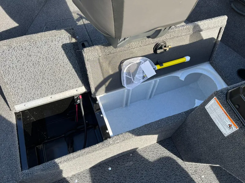 Slide: The Image of 2025 Lund 1650 Rebel XL SS boat interior with storage compartments and fishing net. - 18