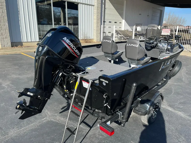 Slide: The Image of 2025 Lund 1650 Rebel XL SS boat with Mercury outboard motor, parked outdoors. - 6