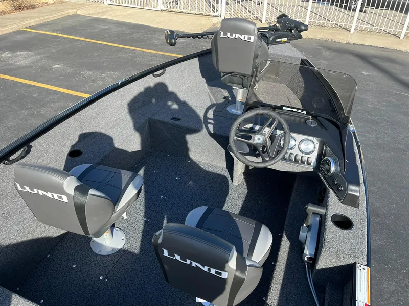 Slide: The Image of 2025 Lund 1650 Rebel XL SS boat interior with steering console and seating. - 8