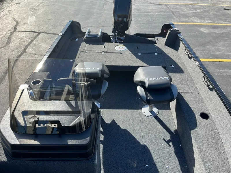 Slide: The Image of 2025 Lund 1650 Rebel XL SS boat interior with seating and steering console. - 9