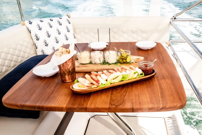 Slide: The Image of Luxurious dining setup on 2022 Regal 42 FXO yacht with appetizers. - 13