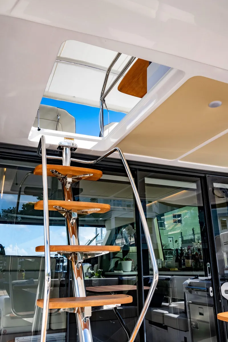 Slide: The Image of Staircase on 2022 Regal 42 FXO yacht, leading to upper deck with modern design. - 14