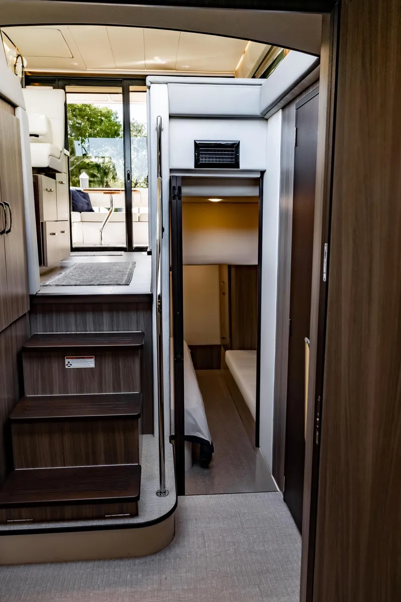 Slide: The Image of Interior of 2022 Regal 42 FXO yacht, featuring modern stairs and cozy cabin space. - 19