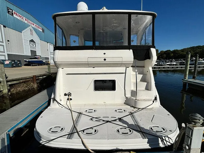 Slide: The Image of 2002 Sea Ray 480 Motor Yacht docked at marina, rear view. - 1