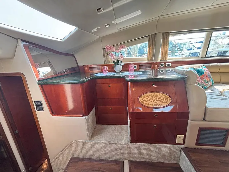 Slide: The Image of Luxurious interior of 2002 Sea Ray 480 Motor Yacht with elegant wood cabinetry and seating. - 19