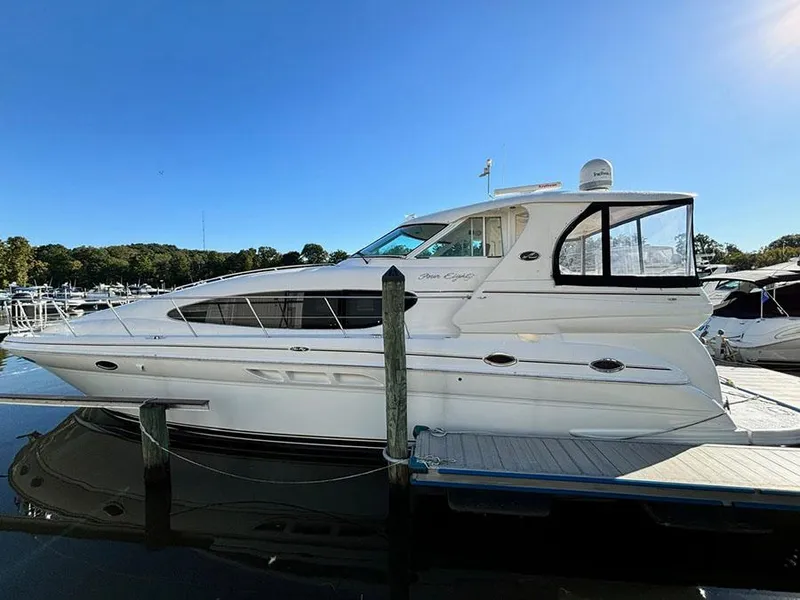 Slide: The Image of 2002 Sea Ray 480 Motor Yacht docked at marina under clear blue sky. - 2