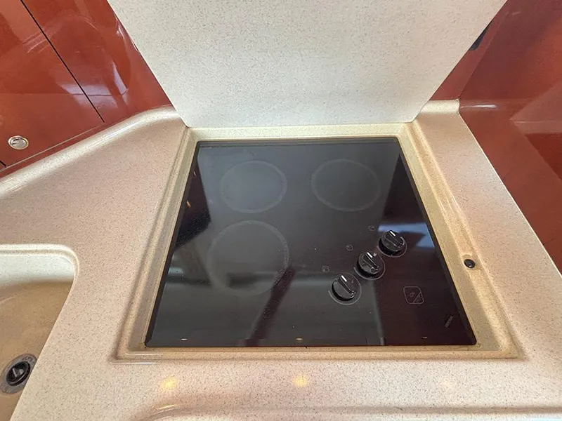 Slide: The Image of Stovetop in 2002 Sea Ray 480 Motor Yacht kitchen, featuring sleek design and modern controls. - 20