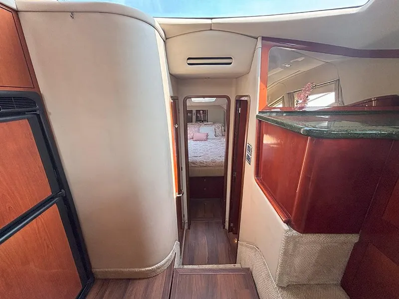 Slide: The Image of Interior of 2002 Sea Ray 480 Motor Yacht with wood accents and cozy cabin view. - 21