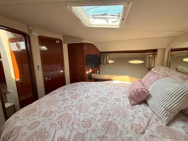 Slide: The Image of Luxurious bedroom interior of 2002 Sea Ray 480 Motor Yacht with skylight and elegant bedding. - 25
